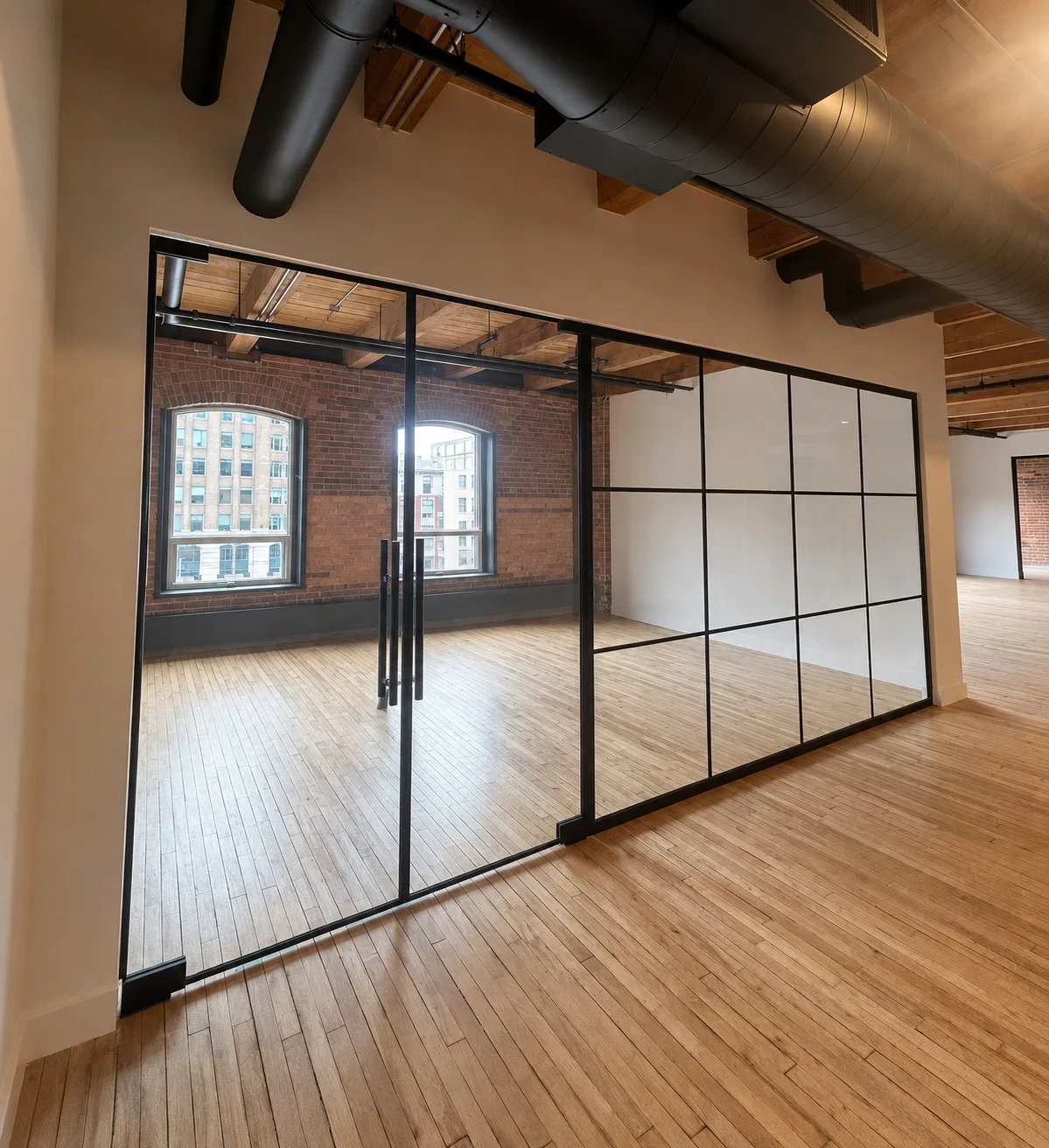 Black aluminum framed architectural glass partition system in a modern interior