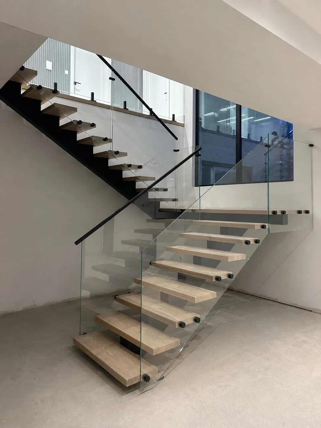 Tempered glass railing panels on a residential staircase