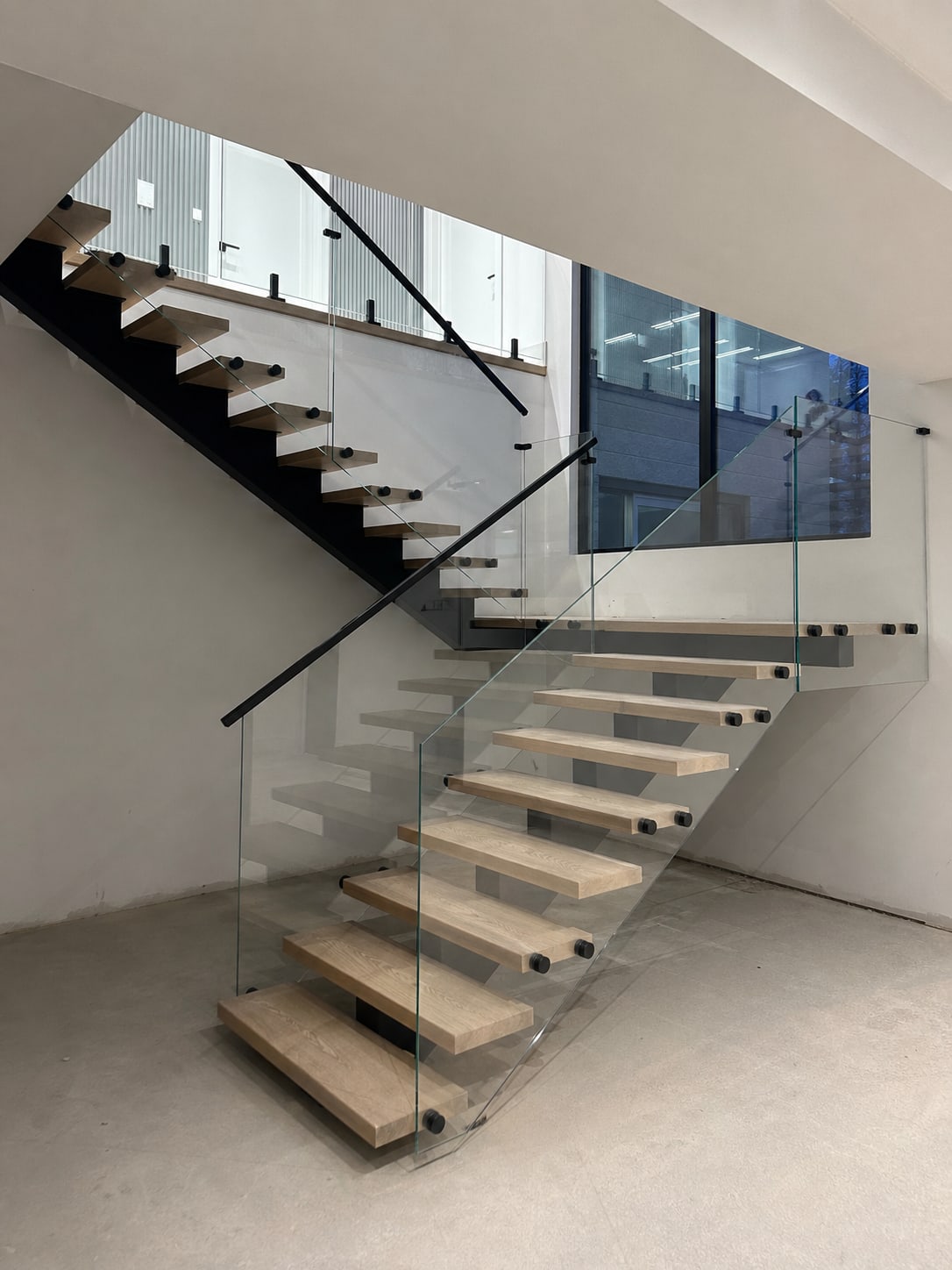Tempered glass railing panels on a residential staircase